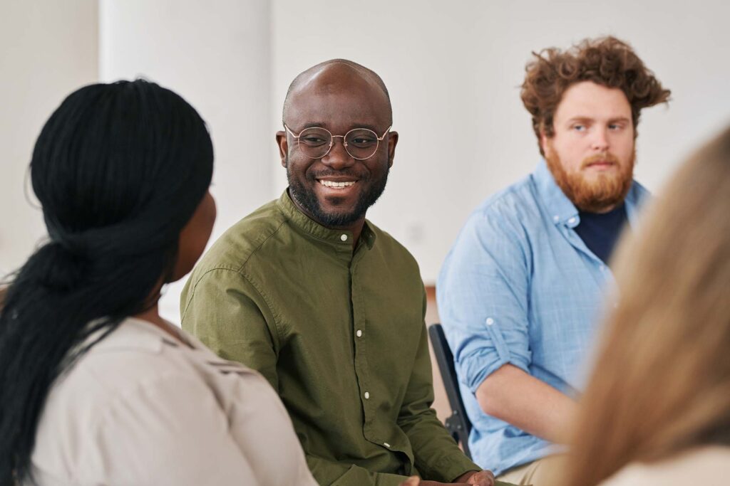 happy young black man looking at one of patients d UT6MESB